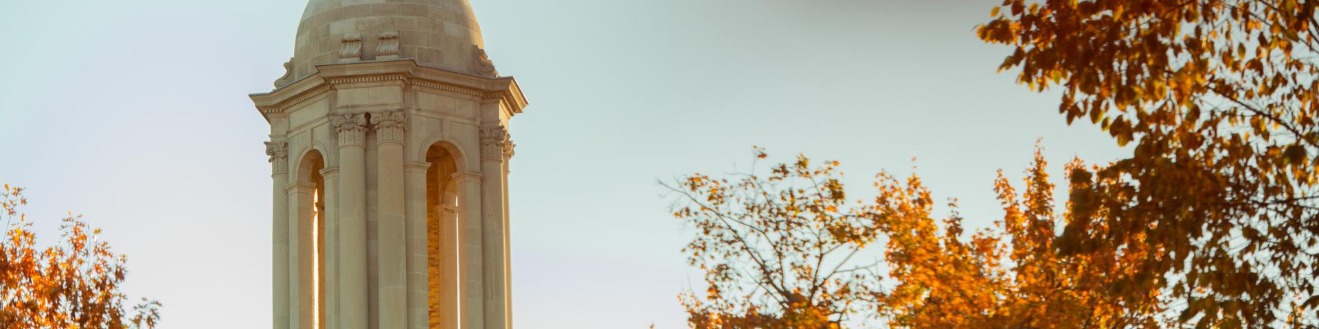 Old Main clock tower with fall foliage 