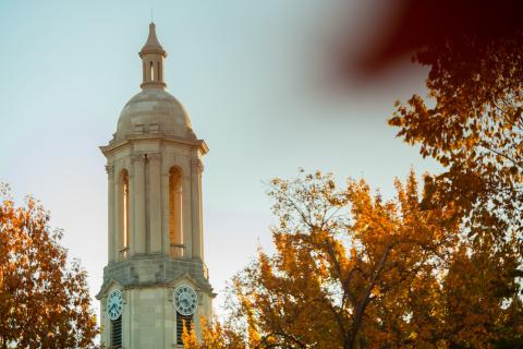 Old Main clock tower with fall foliage 